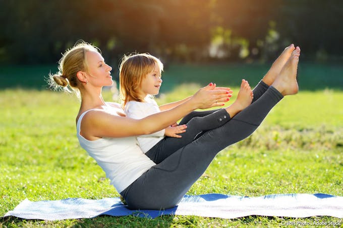 Yoga dans le jardin enfant et femme